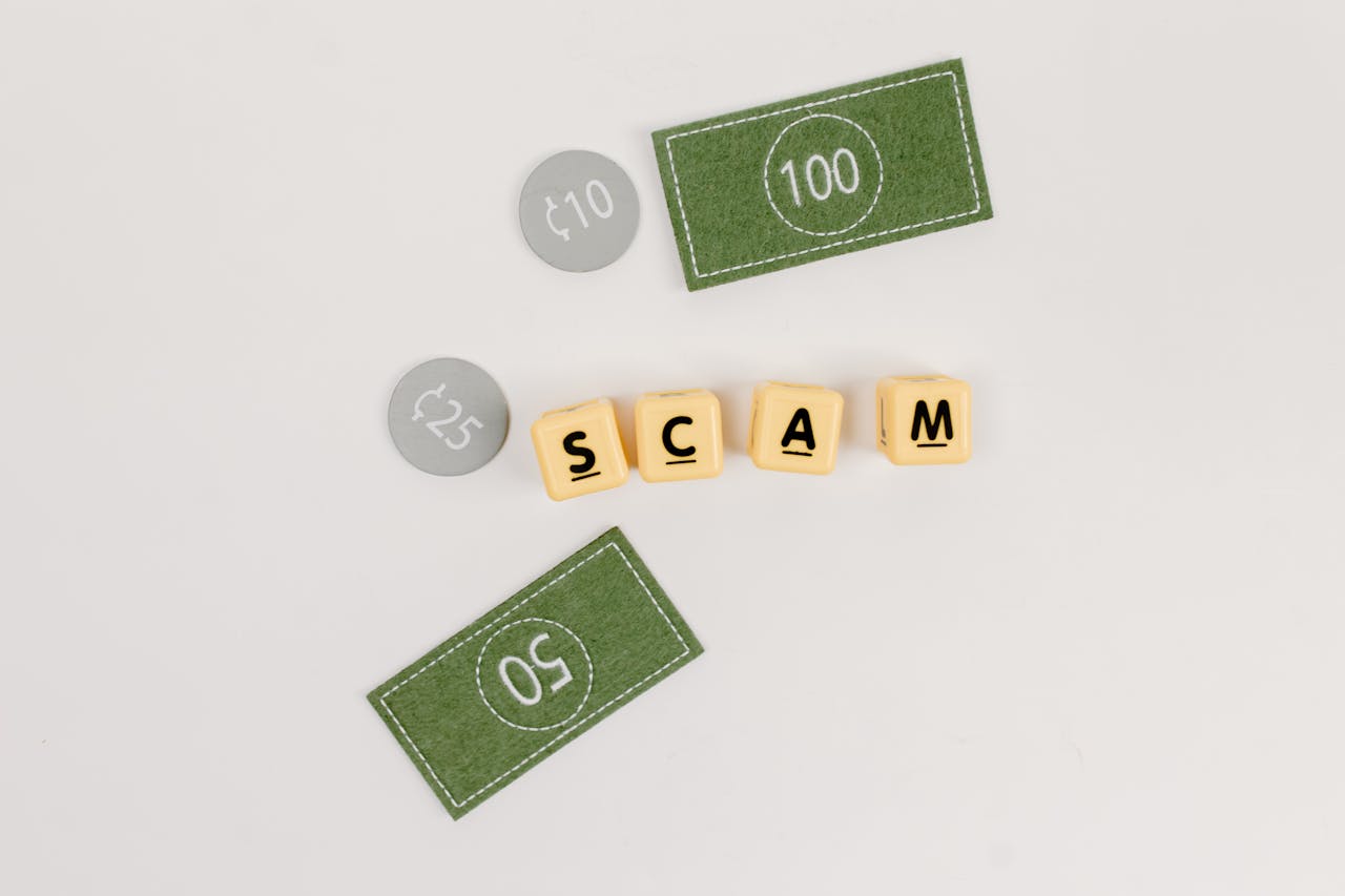 Flat lay of fake currency and scam letters on a gray surface representing financial deception.